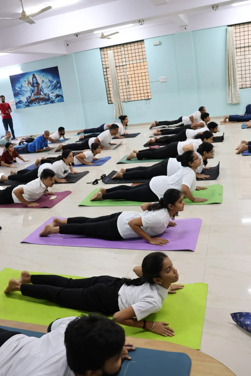 A student in sharp focus holding cobra pose