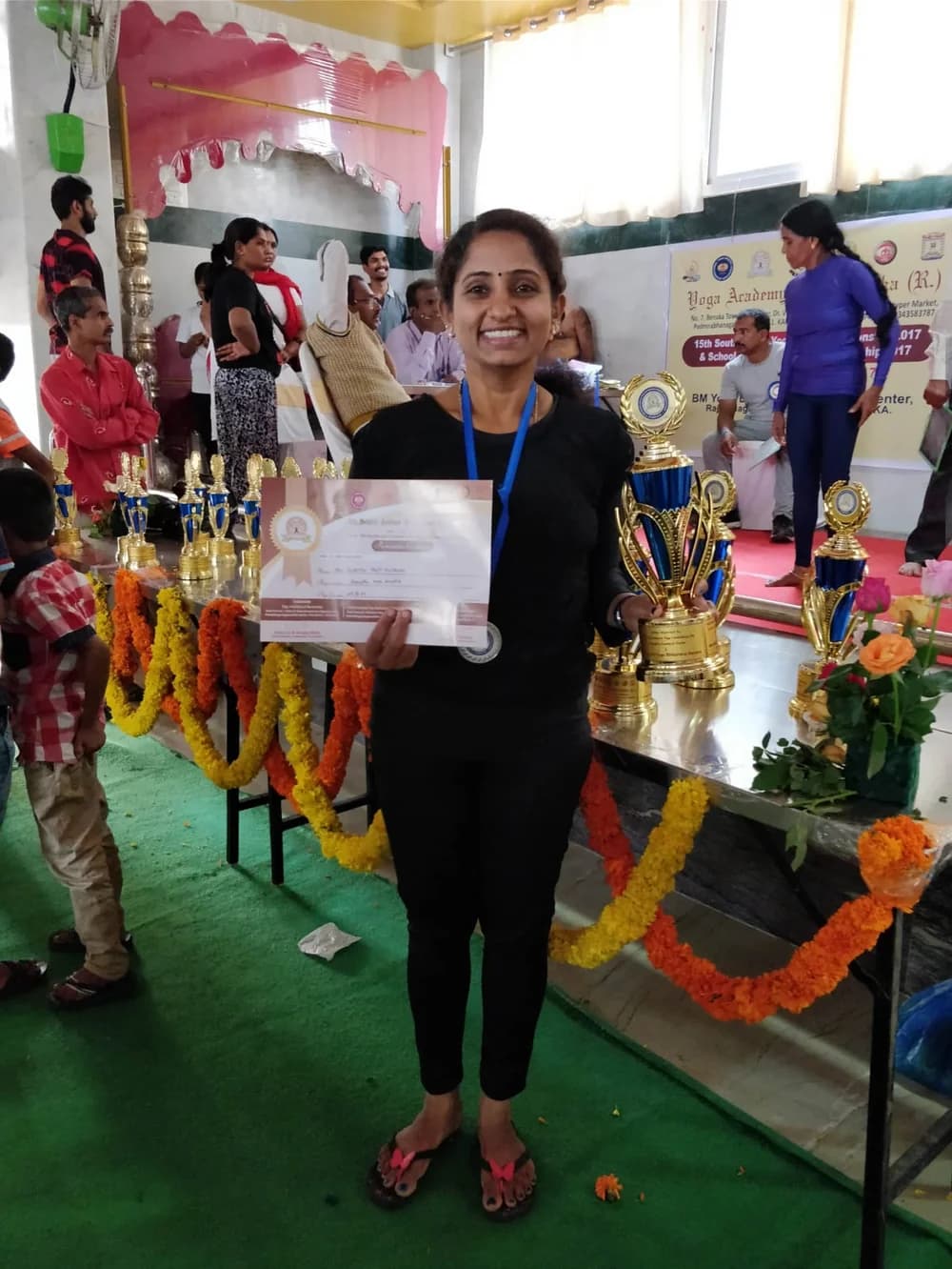 Dr. Sumitra M Patil holding her championship certificate and trophy