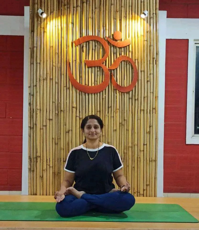 Dr. Sumitra M Patil seated in a lotus pose at the Swastha Yoga studio